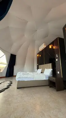a bedroom with a bed in a tent at Rum Paradise luxury camp& BUBBLE in Wadi Rum