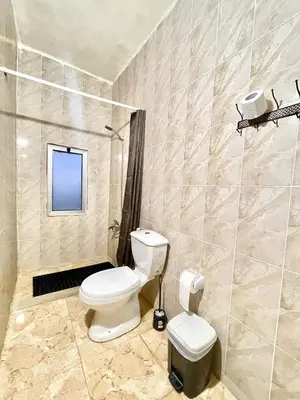 a bathroom with a toilet and a shower at Jabal Dana Hotel - the highest hotel in Jordan in Dana