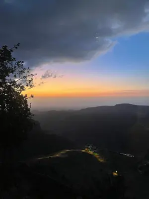 a view of the sunset from the top of a mountain at Jabal Dana Hotel - the highest hotel in Jordan in Dana