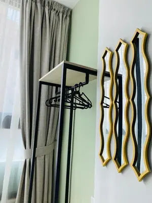 a room with a curtain and a table next to a window at Arabesque Hotel in Amman
