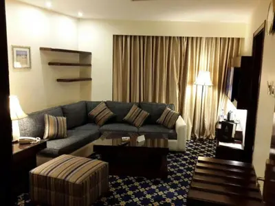 a living room with a couch and a table at Al Thuraya Hotel in Amman