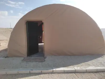 a dome tent with a door in the desert at Mujib Castle Gate Camp in Dhībān