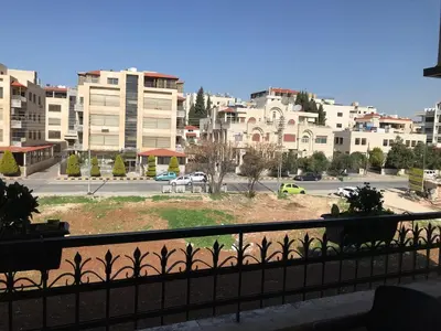 a view of a city from a balcony at Behind Mecca Mall in Amman
