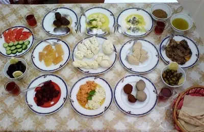 a table with plates of different types of food at RUM SOlARIS BEDOUIN CAMP in Wadi Rum