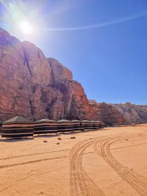 a desert with a mountain in the background at Star City Camp wadirum in Wadi Rum