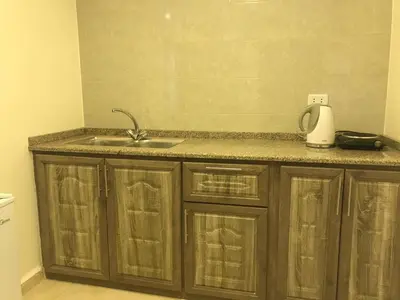 a kitchen with a sink and a counter top at Sultan Home in Wadi Musa