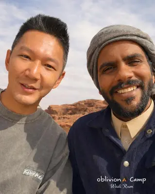 two men are standing next to each other at Oblivion Camp Wadi Rum in Wadi Rum
