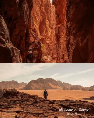 a man walking through a canyon in the desert at Oblivion Camp Wadi Rum in Wadi Rum