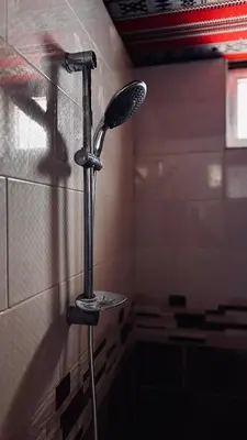 a shower in a bathroom with a mirror on the wall at Oblivion Camp Wadi Rum in Wadi Rum