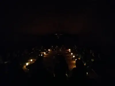 a group of people with candles in the dark at Wadi Rum Excursions in Wadi Rum