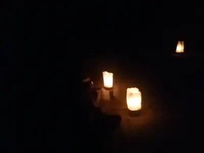 a group of candles sitting on the floor in the dark at Wadi Rum Excursions in Wadi Rum