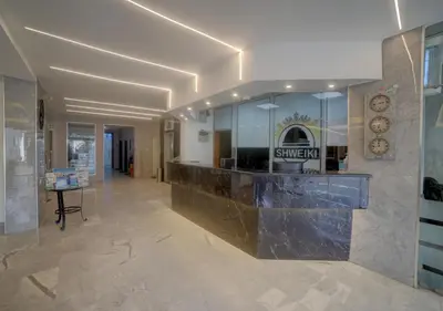 a lobby with a counter in a building at Shweiki International Hotel in Aqaba