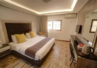 a hotel room with a bed and a television at Shweiki International Hotel in Aqaba