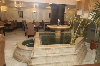 a fountain in the middle of a restaurant at Al Zaitouna Hotel in Aqaba