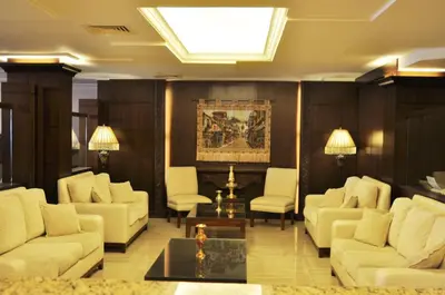 a living room with white furniture and a skylight at Al Zaitouna Hotel in Aqaba