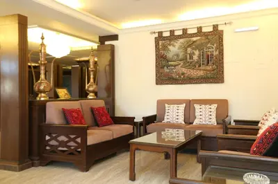 a living room with two couches and a table at Al Zaitouna Hotel in Aqaba