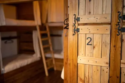 a door in a room with two bunk beds at The Cabin in Amman