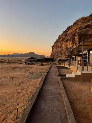 a building in the desert with a mountain at North moon Camp in Wadi Rum