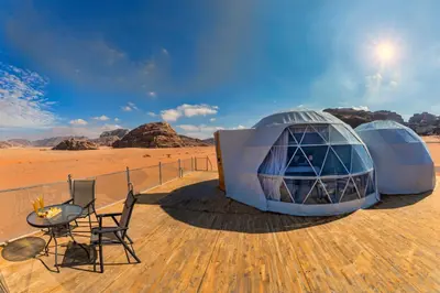 two dome tents on a deck in the desert at Wadi Rum UFO Luxotel in Wadi Rum