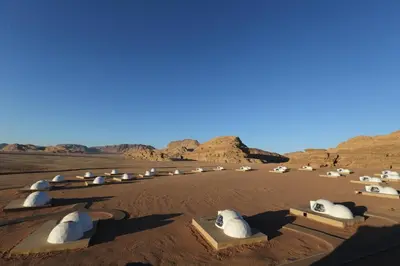 a group of domed buildings in the desert at Wadi Rum UFO Luxotel in Wadi Rum