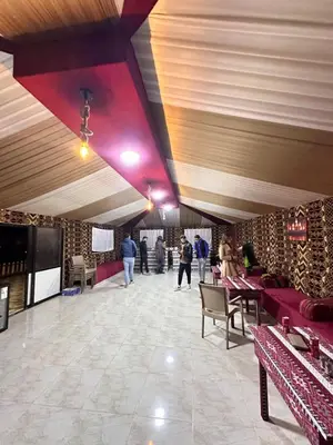a lobby of a restaurant with people walking around at domes wadi Rum in Wadi Rum