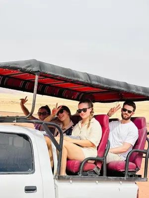 a group of people sitting in the back of a truck at domes wadi Rum in Wadi Rum