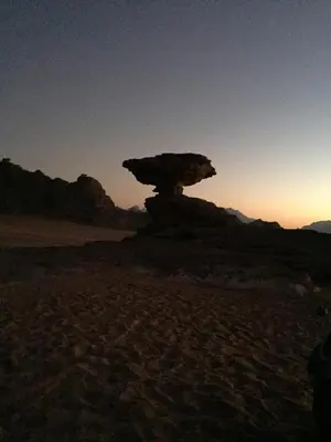 a rock formation in the middle of the desert at Qais Camp Wadi Rum in Wadi Rum