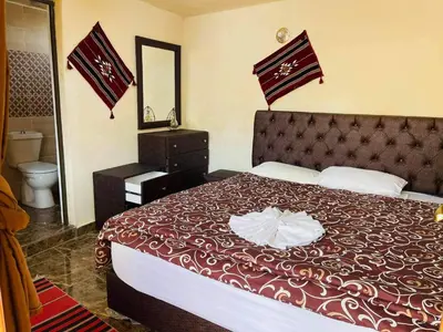 a hotel room with a large bed and a mirror at Dana Gate Lodge in Dana
