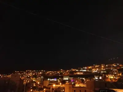 a view of a city lit up at night at Petra Heritage House in Wadi Musa