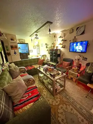 a living room with a couch and a tv at Petra Heritage House in Wadi Musa