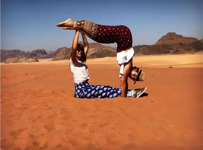a woman sitting on top of another woman in the desert at Landscape Rum Camp in Wadi Rum
