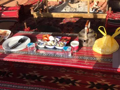 a table with plates and bowls of food on it at Omar Ghazi Camp in Wadi Rum