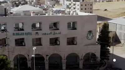 a building with a sign on the side of it at Al-Mujeb in Kerak