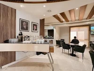 a person sitting at a table in a restaurant at Celino Hotel in Amman