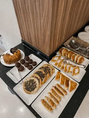 a table topped with different types of pastries and desserts at Celino Hotel in Amman