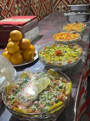 a buffet with bowls of food on a table at Moon city camp in Wadi Rum