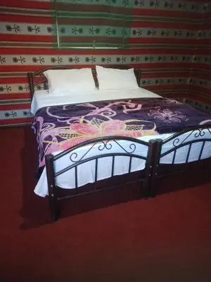 a bed sitting in a room with a wall at Moon city camp in Wadi Rum