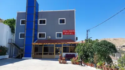a building with a sign that reads main halls hotel at Petra Guests Hotel in Wadi Musa