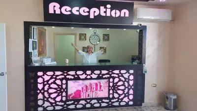 a woman is standing in front of a mirror at Petra Guests Hotel in Wadi Musa