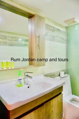 a bathroom with a sink and a toilet at Rum Jordan camp and tours in Wadi Rum