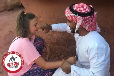 a man and a woman standing next to a girl at Wadi Rum Desert Base Camp in Wadi Rum