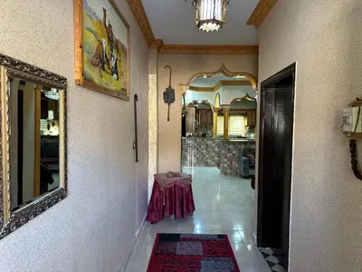 a hallway of a house with a table and a mirror at Petra View Flat in Wadi Musa