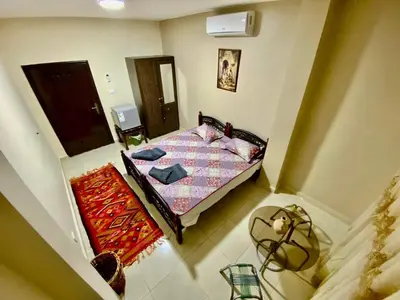 a view of a bedroom with a bed and a mirror at Petra View Flat in Wadi Musa