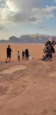 a group of people walking in the desert at bedouin future camp in Wadi Rum