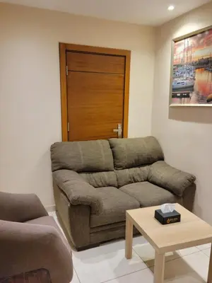 a living room with a couch and a table at Big Ben Hotel Suites in Amman