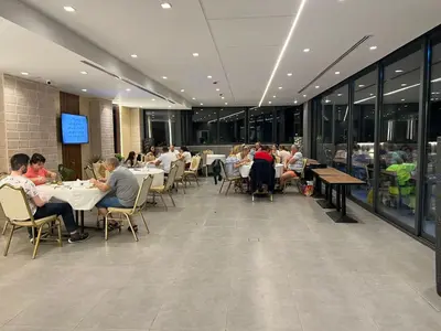 a group of people sitting at tables in a restaurant at mass paradise2 in Aqaba