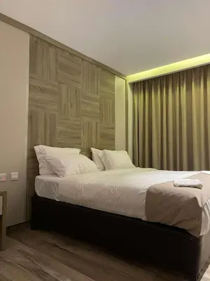 a bedroom with a large bed with a wooden headboard at mass paradise2 in Aqaba