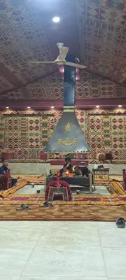 a large bell hanging from the ceiling in a room at Taj Wadi Rum camp in Wadi Rum