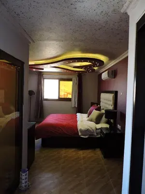 a bedroom with a bed with a red comforter at Valentine Inn Luxury in Wadi Musa