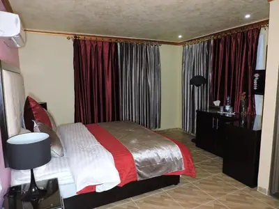 a bedroom with a bed in a room with curtains at Valentine Inn Luxury in Wadi Musa